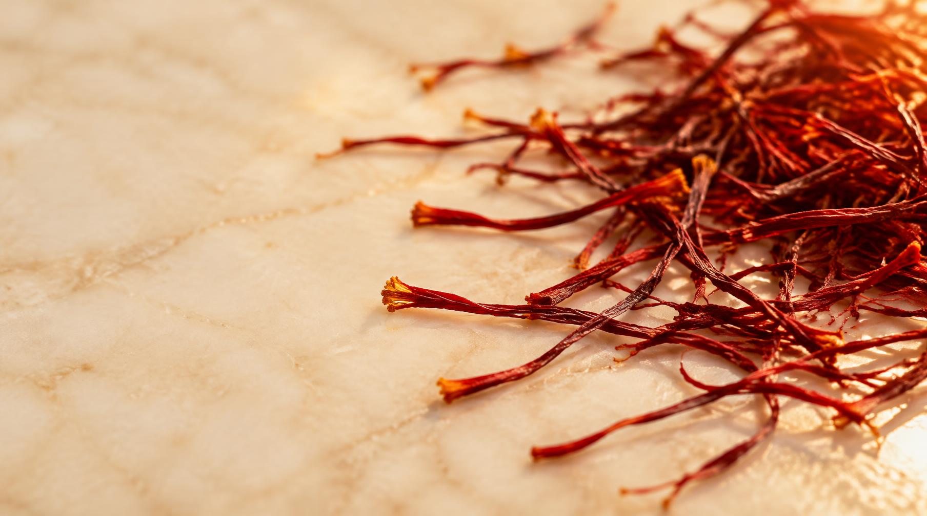 Long saffron strands scattered across a cream surface